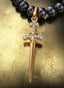 Sword of the Spirit Medallion (Large) with gold connector on a pearl necklace, displayed on a table.