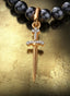 Sword of the Spirit Medallion (Small) with gold connector on a pearl necklace, displayed on a table.