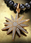 Light of the World Medallion with gold connector on a pearl necklace, displayed on a table.