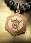 4:14 Medallion with gold hinge connector on a pearl necklace, elegantly displayed on a table.