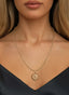 The Genesis Medallion in 14K gold, worn on a necklace, expressing faith and support for Israel.