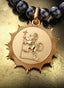 The Genesis Medallion with gold connector on a pearl necklace, elegantly displayed on a table.