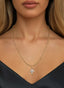 The Finisher Medallion (Medium) in gold, on a necklace, representing faith, redemption, and love.