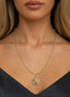 Roots & Branches Medallion in 14K gold, worn on a necklace, expressing faith, unity and divine grace