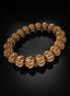 14K Gold Abundant Seed Bracelet angled on black surface.
