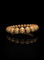 Side view of Abundant Seed Bracelet in polished 14K gold.