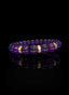 Side view of Abundant Seed Bracelet with amethyst and gold accents.