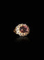 Close-up of pink tourmaline and diamond ring, highlighting gemstone brilliance, on black background.