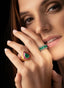 Model wearing emerald and ruby teardrop ring, highlighting size, proportion, and elegance.