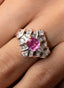Close-up of pink sapphire and diamond baguette ring, showcasing fine craftsmanship.