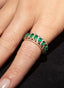 Close-up of stackable emerald and diamond eternity band in 18K yellow gold, showcasing fine details.
