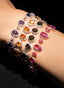 Close-up of sapphire and diamond bracelets on model’s arm, showcasing all four color variations.