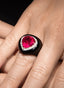 Close-up of rubellite and onyx ring, showcasing intricate craftsmanship and bold design.