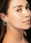 Model wearing emerald and diamond circle earrings in 18K white gold, showcasing their brilliance.
