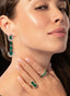 Model wearing 15.17 ct emerald and diamond earrings, highlighting their size and elegant design.