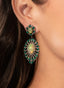 Model close-up wearing emerald, opal, and diamond earrings, showcasing artisan craftsmanship.
