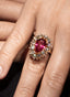 Close-up of rubellite and diamond ring, showcasing intricate craftsmanship.