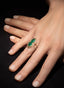 Model wearing emerald and diamond ring, displaying size, proportion, and elegance.