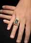 Model's hand wearing an aquamarine and diamond ring, showing its size and graceful proportions.