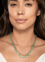 Model wearing emerald fringe necklace, displaying size, proportion, and elegance.