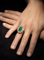 Model wearing emerald and rose-cut diamond ring, displaying size, proportion, and elegance.