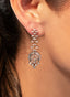 Model wearing diamond dangle earrings in 18K gold, showcasing their brilliance and look.