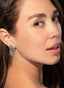 5.5 carat emerald and diamond earrings in 14K white gold on model, exhibiting size and elegance.