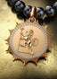 The Genesis Medallion with gold connector on a pearl necklace, elegantly displayed on a table.