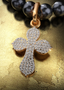 The Finisher Medallion (Medium) with connector on a pearl necklace, elegantly displayed on a table.