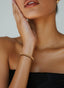 Gold Cross of Faith bracelet on a woman's wrist, showing size, fit and elegance.