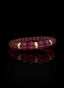 Side view of Abundant Seed Bracelet with ruby and gold accents.