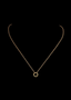 18" INSPOCCO 14K gold link chain featuring a center gold ring, on black background.