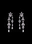 Diamond double dangle earrings in 18K white gold, displayed against a black background.