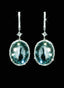 39.43 ct aquamarine and diamond drop earrings in 18K gold, displayed against a black background.