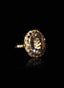 Close-up of morganite and diamond ring on black bacground, showcasing gemstone brilliance.