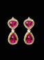 Pink tourmaline and diamond drop earrings on black background, highlighting craftsmanship.