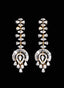 Diamond dangle earrings in 18K yellow gold with fancy cut diamonds, against black background.